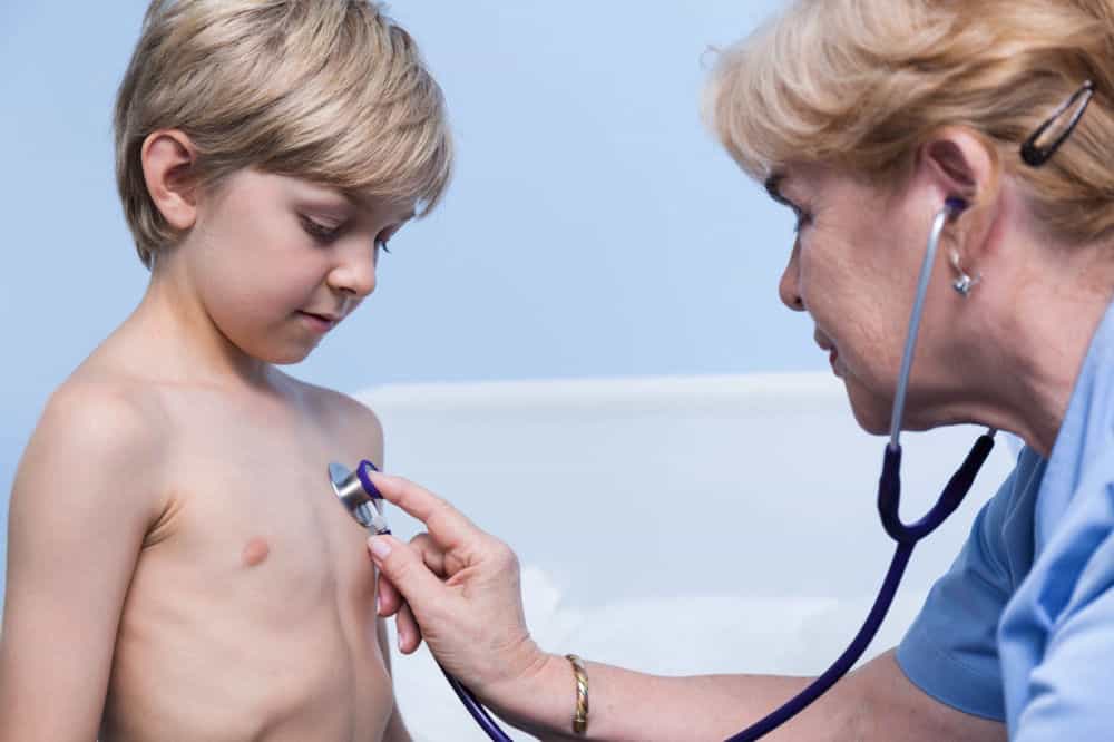 nurse checking child's chest