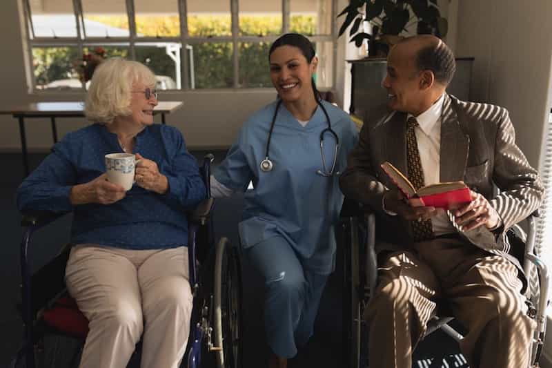 nurse with an elderly couple in livingroom